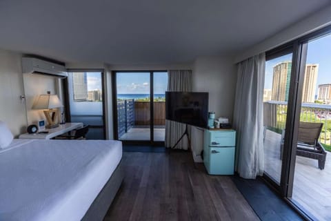 Room with wide windows and a terrace facing city and ocean