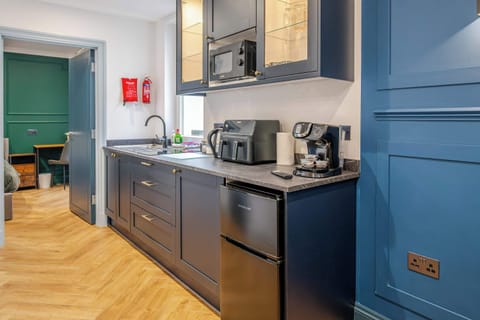 Open plan kitchen and living space. The kitchen has everything you could possibly need for your stay, including utensils, kettle, toaster, fridge, microwave and a hob. Please note there is no oven.
