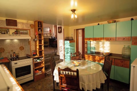 Large kitchen with ample counter space and vintage cabinets.