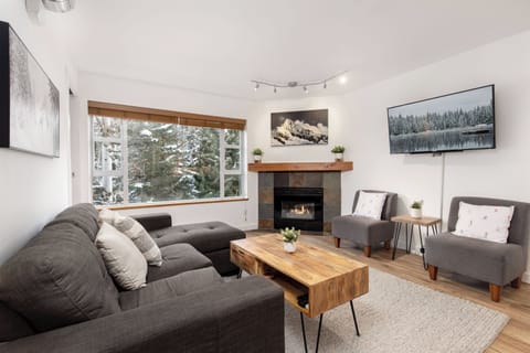 Bright living room with treed views