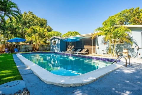Escape to this tropical retreat with a sparkling pool, shaded patio, and lush greenery. A perfect Airbnb for relaxing under the palms and soaking up the sun.
