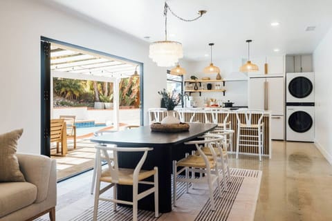 As you sit at the dining table for 6-8, natural light fills the space through the bi-fold door, blending the indoors with the outdoors. The open-concept design lets you enjoy meals while soaking in the fresh air and vibrant backyard atmosphere.