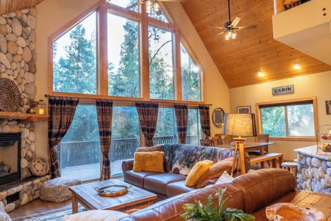 Soaring vaulted ceilings, walls of windows and gas fireplace