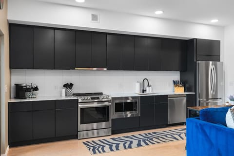 Fully equipped kitchen for all of your cooking needs! Keurig coffee machine + K-cups provided plus seating for 4 at the high-top table behind the couch.