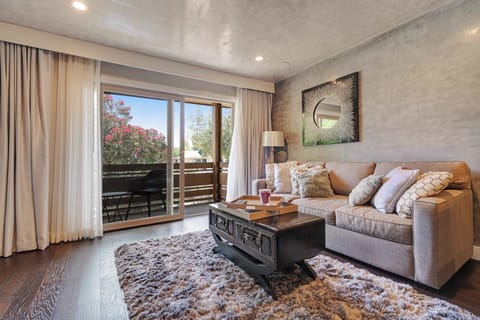 Living room with widen open access to the balcony that extends across the whole unit. 