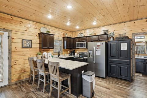 Your rustic kitchen offers modern appliances and cozy log cabin charm, perfect for preparing meals together.