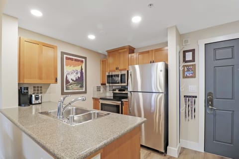 Your fully equipped kitchen features granite countertops, stainless steel appliances, and warm wood cabinetry to make meal preparation a joy.