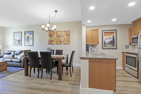 Relax in your spacious open-concept living area with a fully equipped kitchen, comfortable dining space for six, and cozy seating area perfect for unwinding after your adventures.