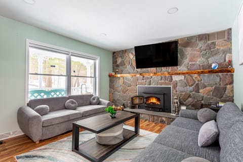 Cozy living room with stone fireplace, Smart TV & plush seating