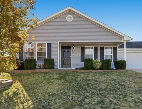 Front exterior featuring a small seating area.