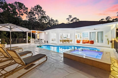 Golden hour in Naples-Florida, where warm skies meet a glowing pool, palm trees sway, lounge chairs invite you to unwind, and the softly lit home opens to the patio. Breathe in… this is your escape.