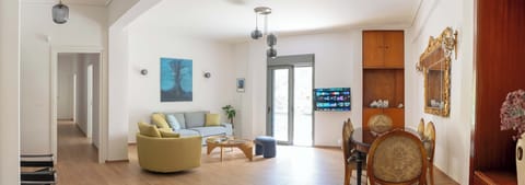 An inviting living room, with comfortable seating, and plenty of natural light