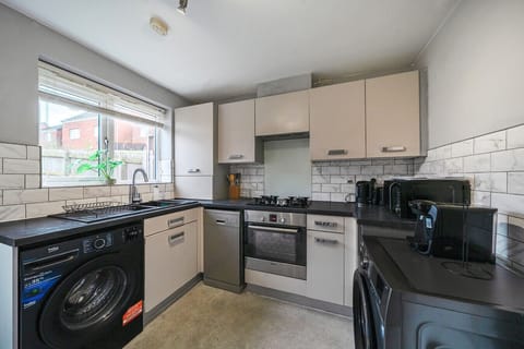 Alternative kitchen view showing additional worktop space and the cooking area.