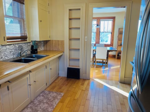 Charming kitchen with shaker cabinets, hardwood floors, new stainless appliances