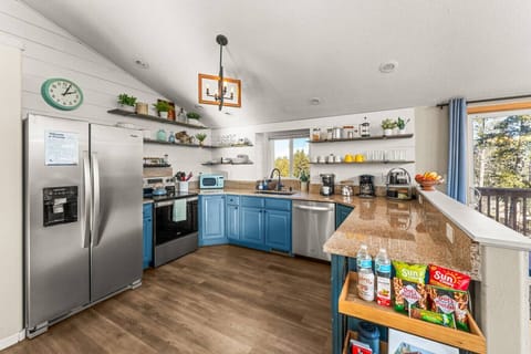Fully stocked kitchen with stainless appliances, coffee bar, open shelving, and plenty of counter space. Perfect for cooking family meals after skiing or hiking. Includes drip + Keurig, toaster oven, spices, and all essentials for your mountain stay.
