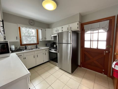 The kitchen boasts a new range and refrigerator, and a countertop dishwasher.
