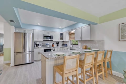 Open, bright, and ready to serve—our kitchen is basically an invitation to gather, laugh, and eat your way through vacation.