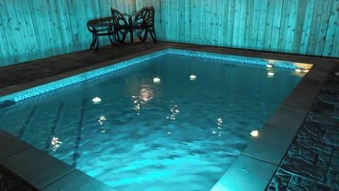 Serene Glowing Poolside Retreat Oasis
Dive into bliss at this enchanting pool haven, illuminated by mesmerizing blue lights at night. Lounge on stylish chairs by the wooden fence, surrounded by sleek stone decking.