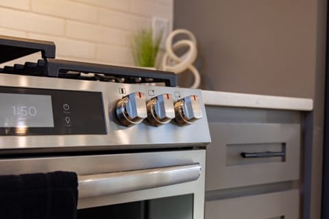 Professional-grade kitchen features a modern gas stove and oven, providing everything needed for home-cooked meals.