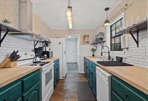 Fully equipped kitchen with modern appliances, open shelving, and plenty of counter space.