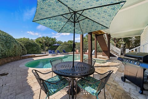 Shaded poolside dining perfect for BBQ lunches and warm island evenings.