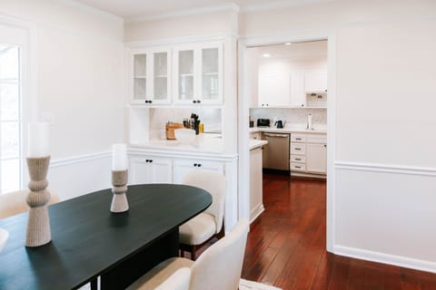 Bright dining flow into a pristine kitchen designed for effortless hosting.