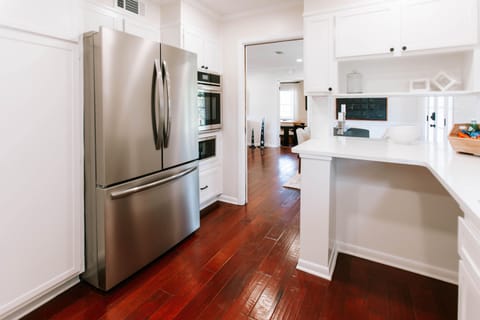 Sleek stainless appliances and warm wood floors highlight this kitchen.