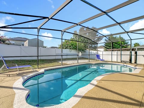 Screen-enclosed pool offers a refreshing spot to swim & relax in a bright outdoor setting.