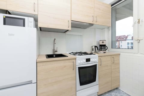 The kitchen's sleek design includes all necessary cookware and utensils.