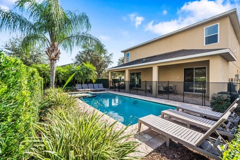 Relax by the private pool w/ loungers & lush greenery in a peaceful backyard setting