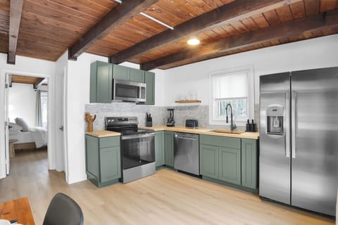 Cook and gather in the bright, modern kitchen featuring new stainless steel appliances, warm wood ceilings, and thoughtful finishes throughout. Designed for easy meals and shared moments, it’s a welcoming space to start and end your day.