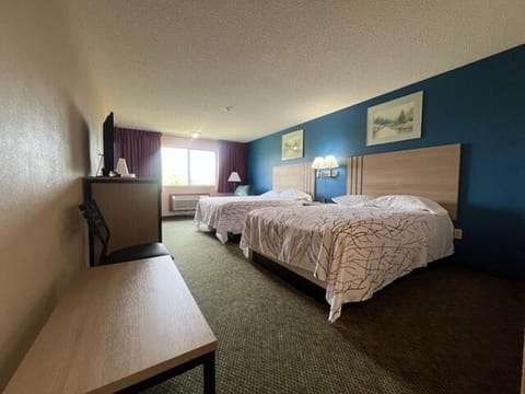 Wake up to natural light in a spacious double-queen room.