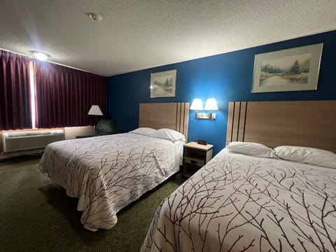 Unwind together in bright double beds with cozy linens.