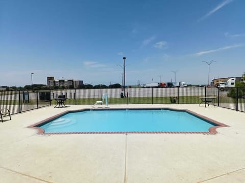 Dive into sun-soaked relaxation in this sparkling outdoor pool.