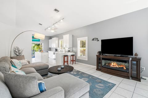 Relax in your open-concept living space with comfortable sectional seating, modern fireplace, and fully equipped kitchen - perfect for unwinding after a day of adventures.