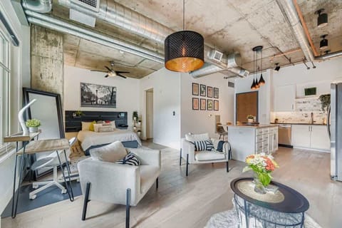 Bright open-plan home featuring updated modern furnishings, warm natural light, and a comfortably designed layout. Sleek décor, a well-equipped kitchen, and a cozy sleeping area create an inviting, functional space perfect for relaxing or working.