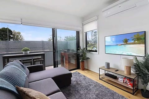Living room with flat-screen TV and comfortable couch 