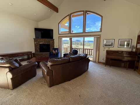 Wrap around deck that overlooks Eleven Mile Reservoir and 10 Mile Range with dining table and swing