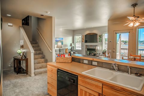 Bright kitchen overlooks a relaxing living room — perfect for family stays.