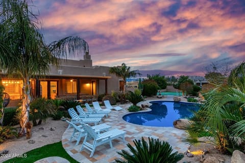 Backyard night view of custom pool