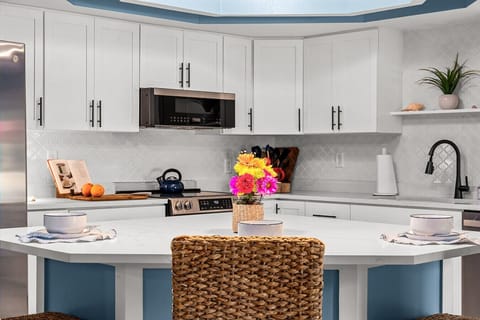 Bright, modern chef’s kitchen with spacious island seating — perfect for cooking together and gathering over morning coffee.