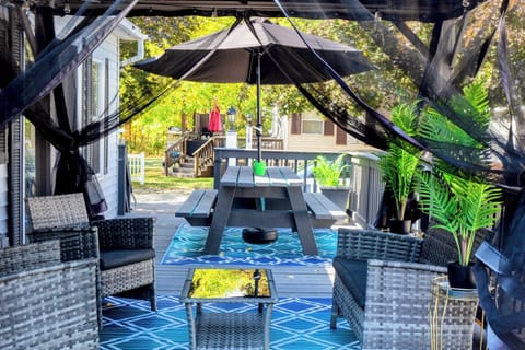 Exterior:Deck -covered gazebo, patio furniture; large picnic bench with umbrella