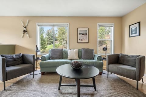 Main floor living room with cozy seating options, Smart TV, and an electric fireplace.