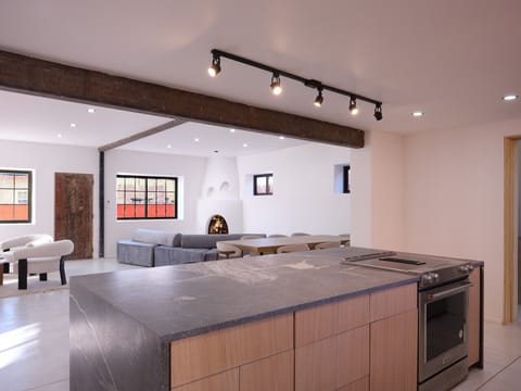 Modern Adobe: 1940s history with white cement, Italian granite, and kiva warmth.