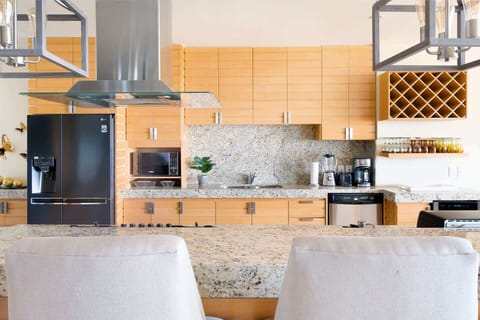 Kitchen | Relax at the bar while a chef prepares meals, turning cooking into a shared experience.