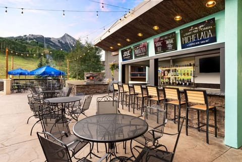 Outdoor dining patio with mountain views and fire pit