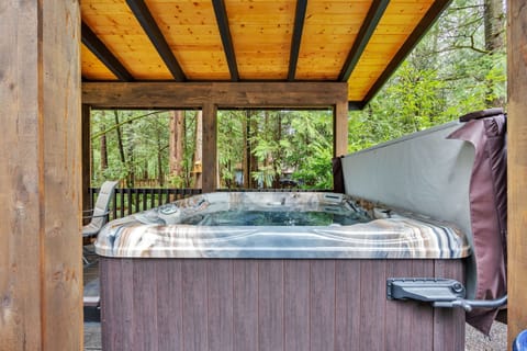 Private hot tub retreat under a cedar canopy—soak, unwind, and enjoy peaceful forest vibes year-round.