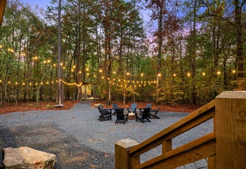 Twinkling lights and a cozy fire pit set the scene for memorable outdoor evenings filled with warmth and laughter.