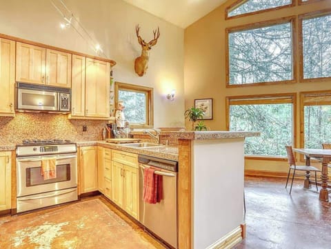 Kitchen has one touch microwave with exhaust fan, gas cook top and electric convection oven with warming drawer below, dishwasher, two door fridge/freezer, toaster oven, blender, toaster, drip coffee maker and bean grinder.