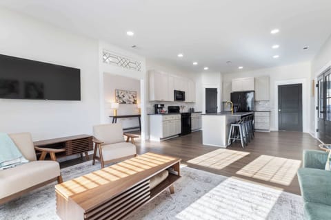 This living room blends right into the kitchen, creating a warm space where cooking, lounging, and gathering all come together effortlessly.